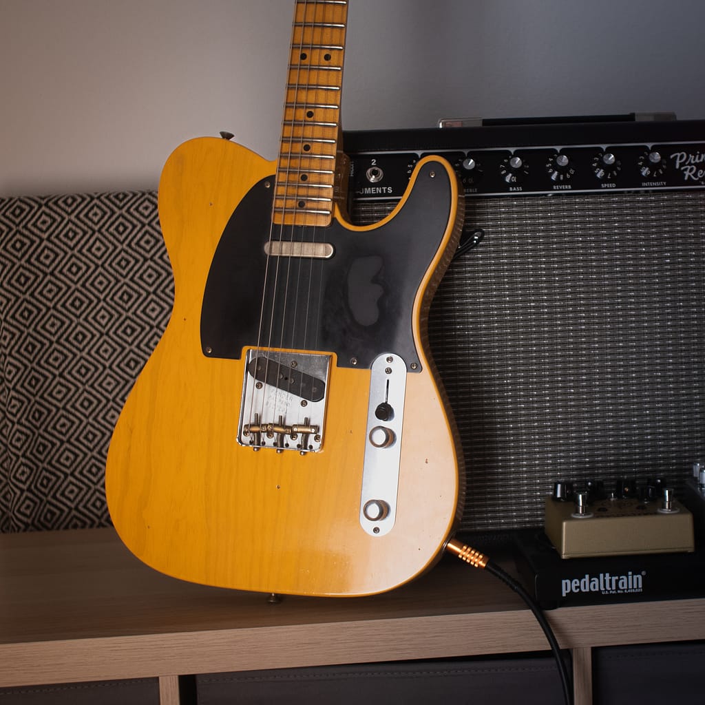 butterscotch blonde telecaster in front of a fender amp